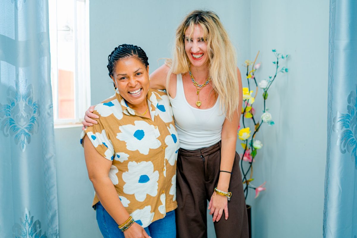 A school director from Tanzania warmly welcoming a visiting school director from Greece